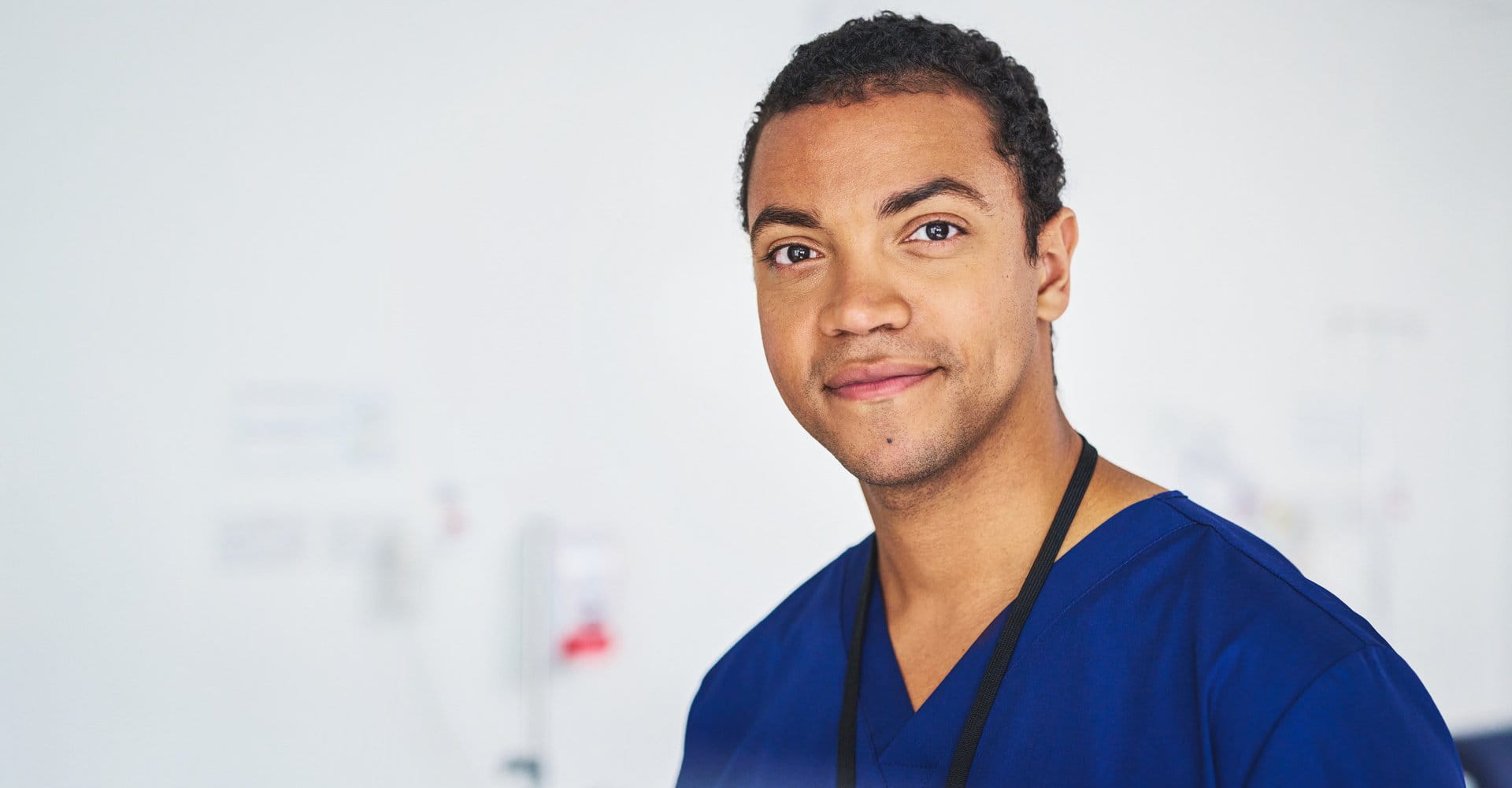A male nurse looking directly at the camera.