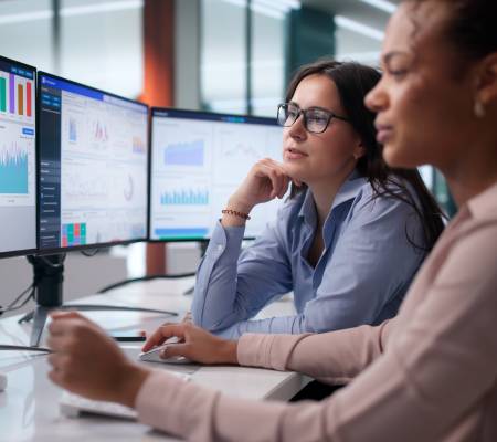Diverse Women On Analytics Team Analyzing Financial Data At Office.
