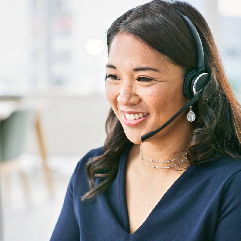 An associate using a headset to speak on the phone.